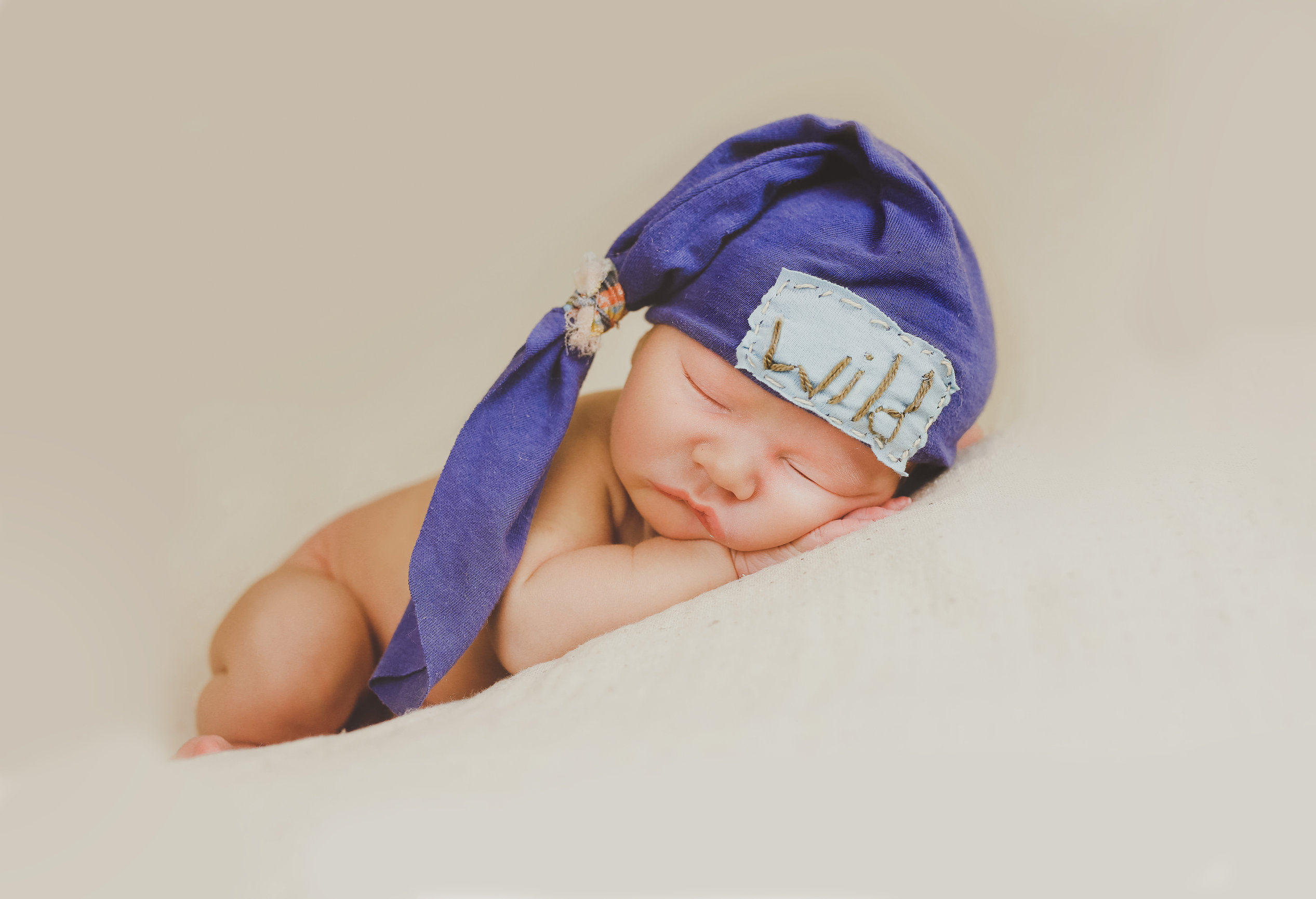 Sleeping newborn on pink