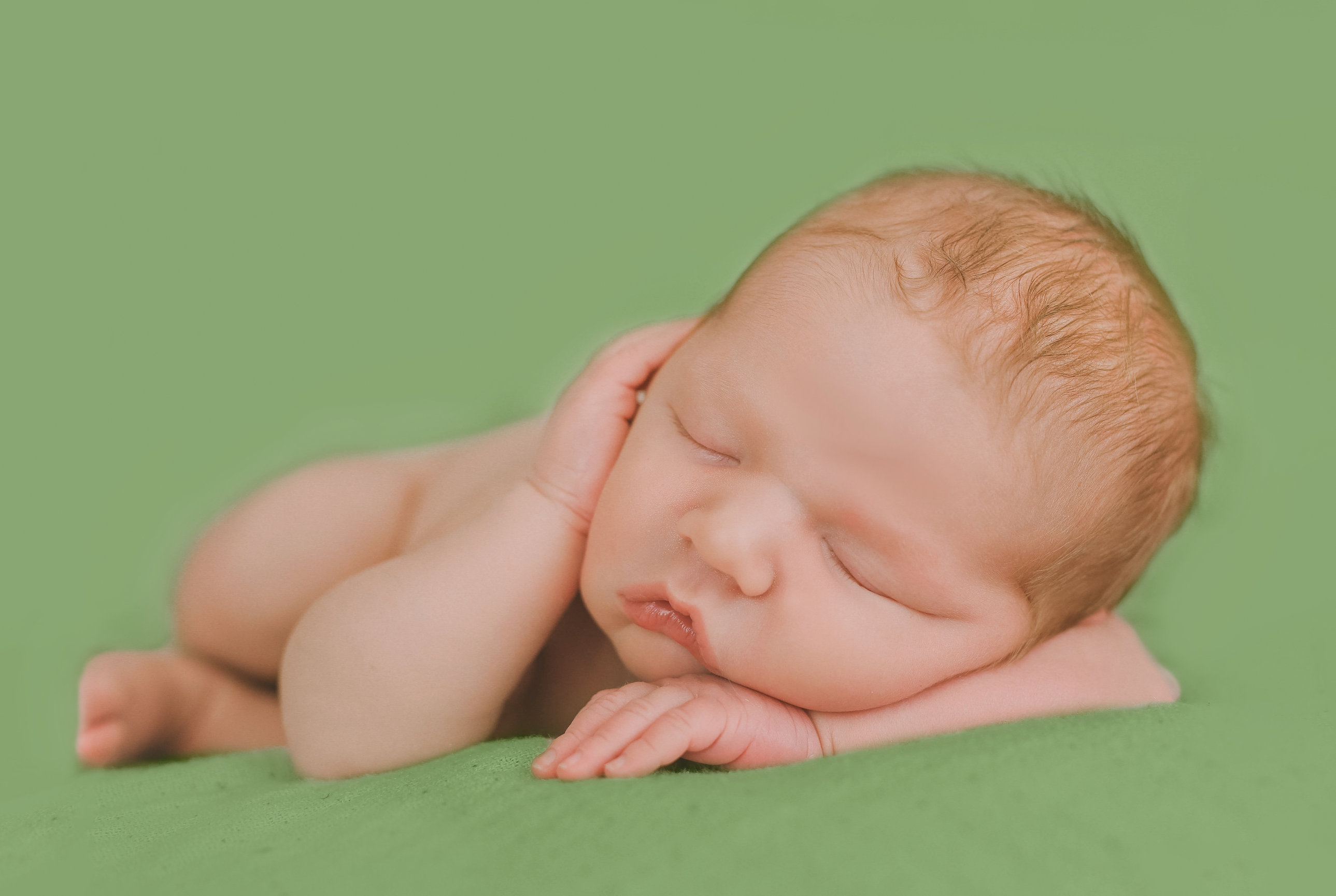 Newborn with sunflower crown on yellow